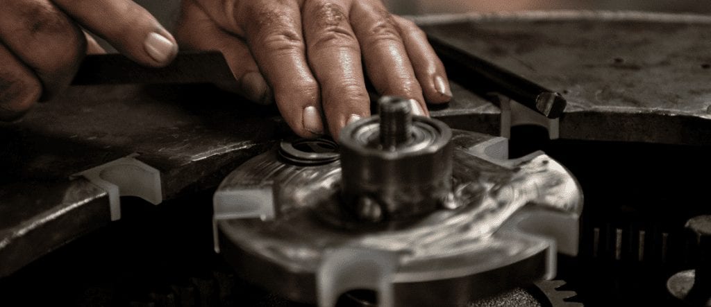Man repairing a machine and providing technical support